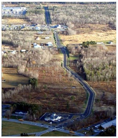 Aerial photograph of a long winding road.